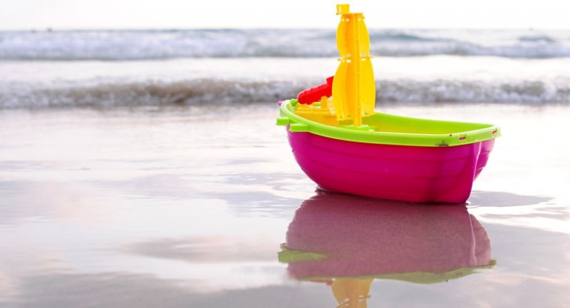 Toy boat on the beach
